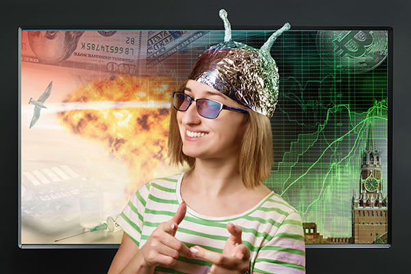 Smiling woman in a tinfoil hat in front of a TV screen with metaphors of news topics on it.